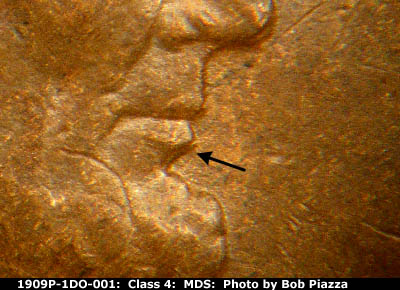 Die-stage B marker on 1909P•1DO•001 showing Die chip near lip.