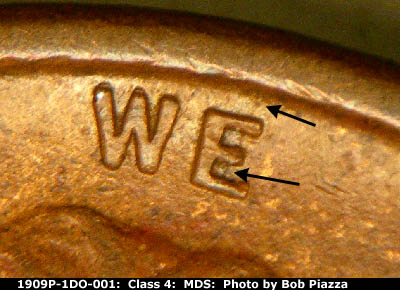 Die-stage B marker on 1909P•1DO•001 showing For crack from rim though E in WE.
