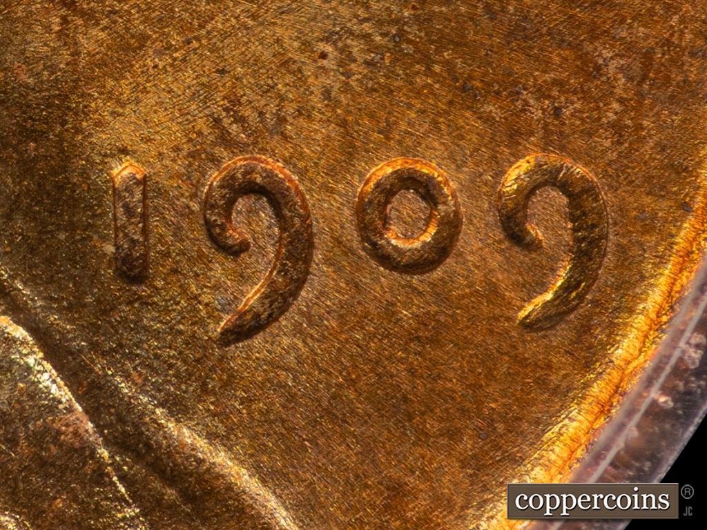 Die-stage A marker on 1909P•1DO•002 showing Extra thickness on Date.