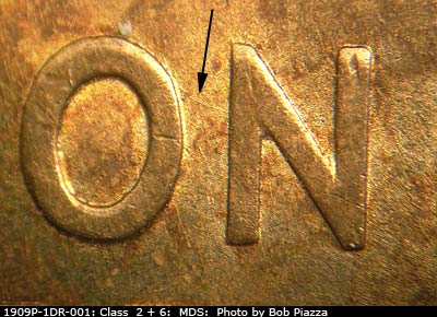 Die-stage B marker on 1909P•1DR•001 showing SE die scratch connecting O and N of ONE.