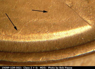 Die-stage B marker on 1909P•1DR•002 showing Die crack on shoulder.