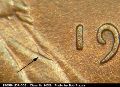 Die-stage B marker on 1909P•1DR•003 showing Die crack on shirt below bowtie.