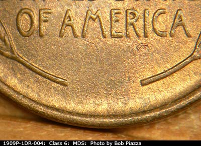 Die-stage B marker on 1909P•1DR•004 showing Lower part of the reverse design showing die wear.