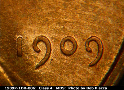 Die-stage B marker on 1909P•1DR•006 showing Date area showing characteristics of the die flow in the area.