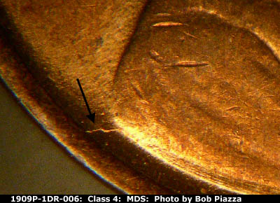 Die-stage B marker on 1909P•1DR•006 showing Die crack runs from the back of the shoulder to the rim.