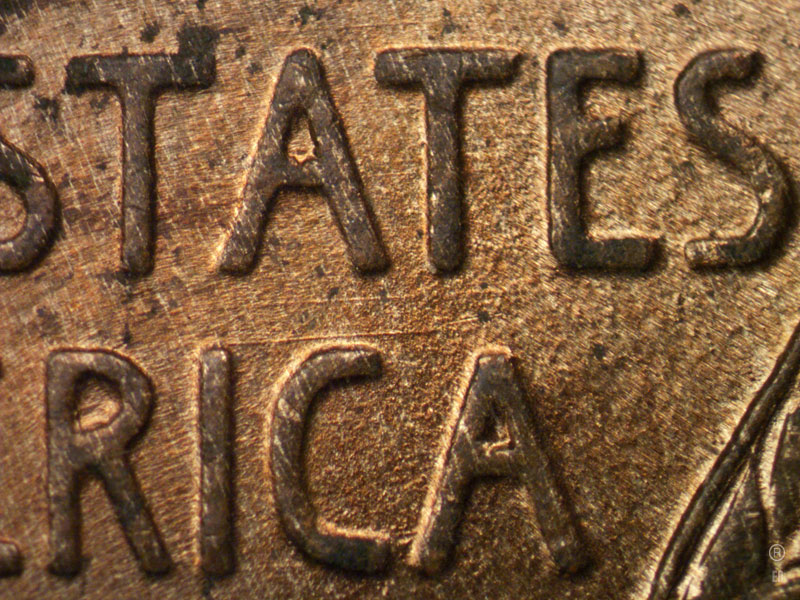 Die-stage B marker on 1909P•1DR•007 showing Two Parallel horizontal die scratches show between STATES and AMERICA.