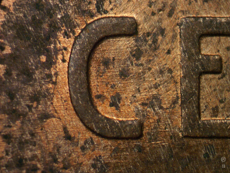 Die-stage B marker on 1909P•1DR•007 showing Horizontal die scratches in the area of the C of CENT.