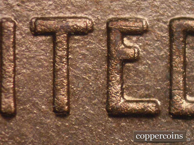 Die-stage A marker on 1909P•1DR•008P showing Doubling on the TE of United shows as small characters over larger characters. This is class 3 doubling which means t….