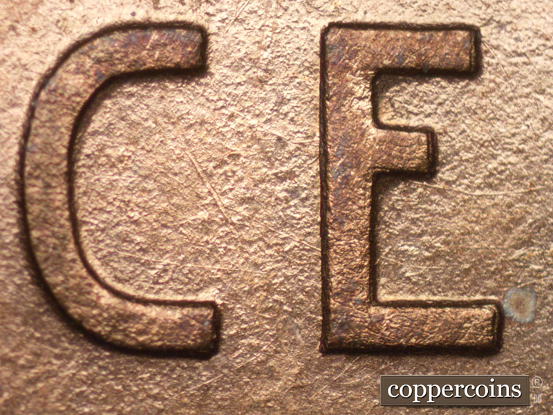 Die-stage A marker on 1909P•1DR•008P showing A few small die scratches show inside the C of CENT.