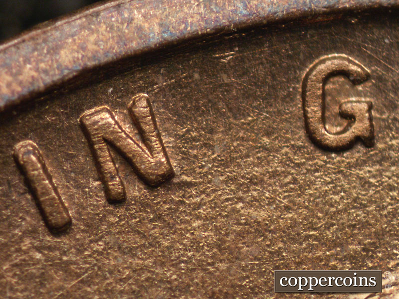 Die-stage A marker on 1909P•1DR•008P showing A short die gouge shows on the lower right corner of the N of IN.
