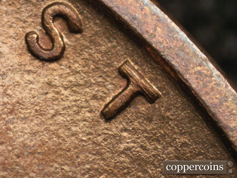 Die-stage A marker on 1909P•1DR•008P showing Very thin and difficult to detect, die scratches show beneath the last T of TRUST.