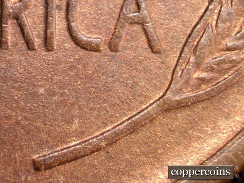 Die-stage B marker on 1909P•1DR•009 showing Extra thickness seen on right wheat stem.