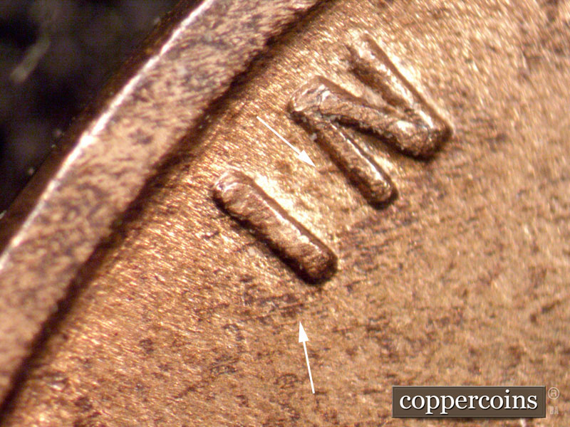 Die-stage A marker on 1910S•1MM•001 showing Short die gouges show on the word IN.