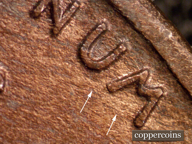 Die-stage A marker on 1910S•1MM•001 showing Light die scratches seen in the area of the Umm of Unum.