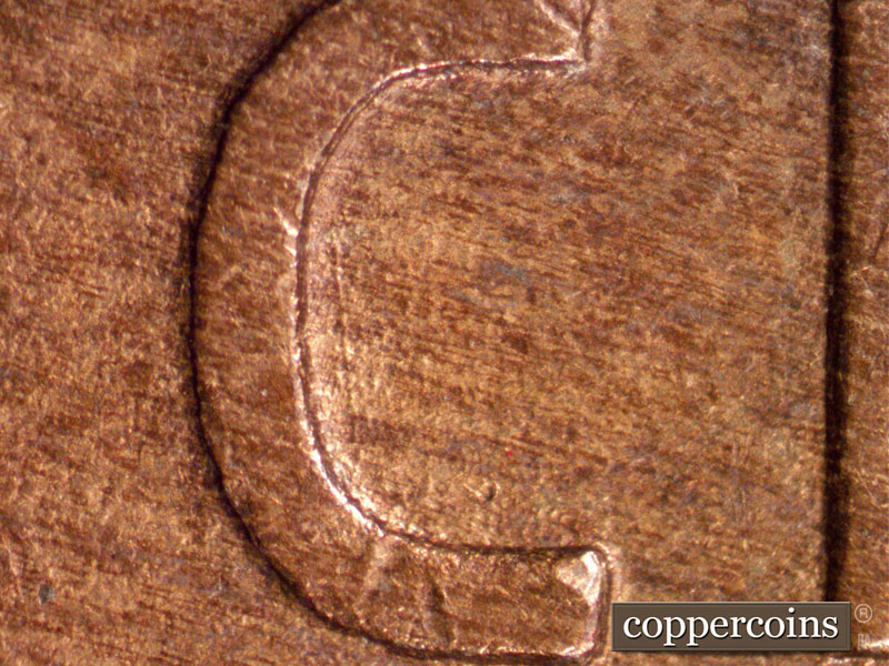 Die-stage A marker on 1910S•1MM•001 showing Long vertical die scratch inside the seat of cent.