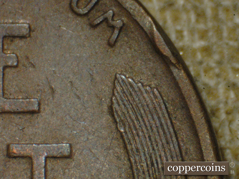 Die-stage A marker on 1910S•1MM•004 showing A heavy die dot shows to the right of the center of the E of one.
