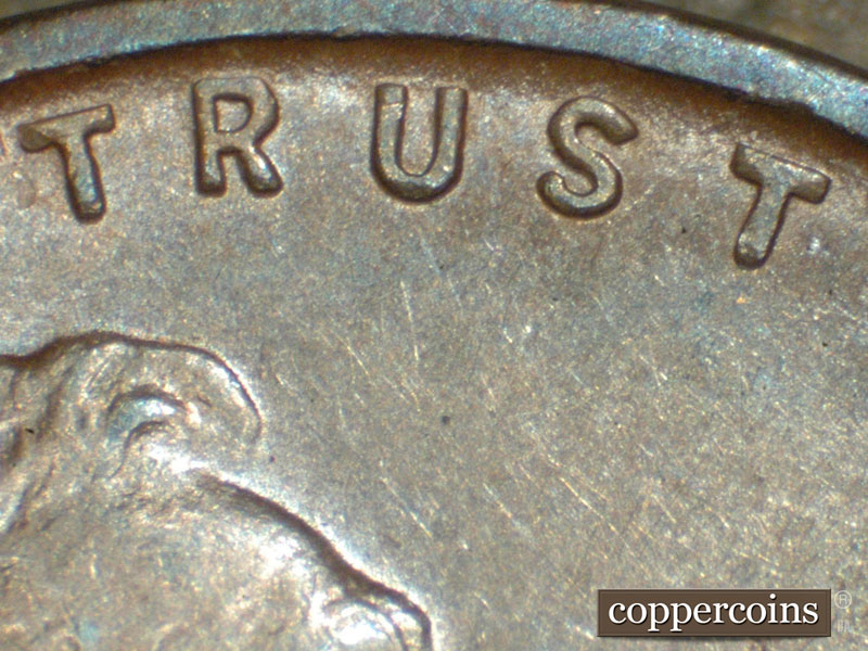 Die-stage C marker on 1911D•1MM•001 showing A small die dot above the left crosslet of the second T of trust.