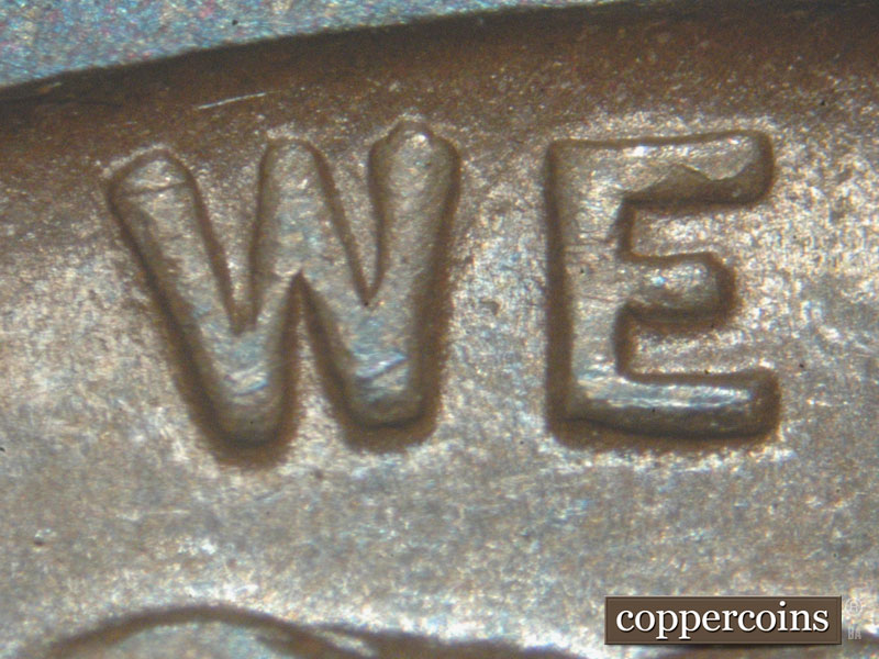 Die-stage C marker on 1911D•1MM•001 showing A small die crack shows on the top of the E of WE.