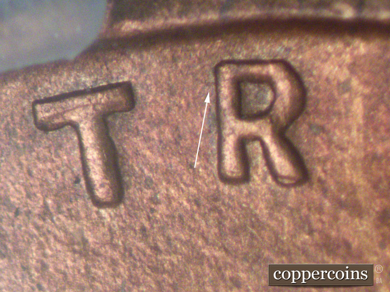 Die-stage A marker on 1911D•1MM•002 showing Small die scratch by R in TRUST of motto.