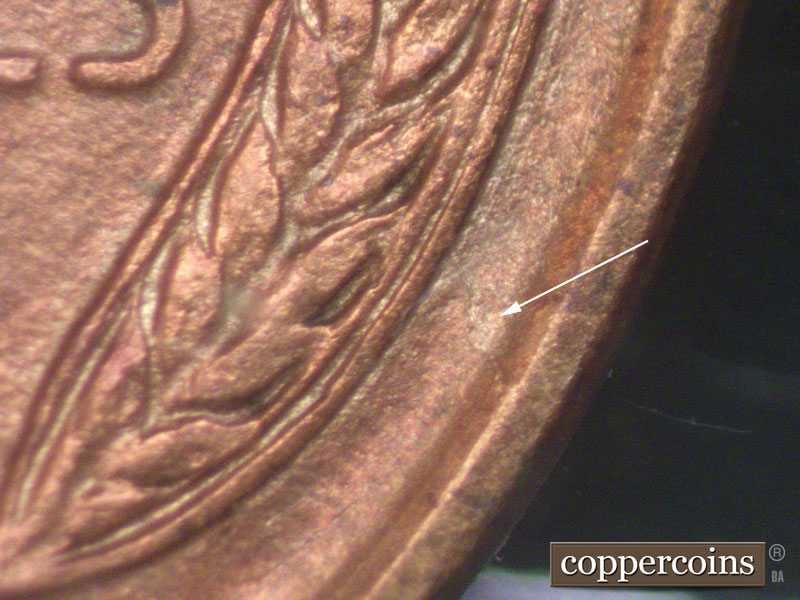 Die-stage A marker on 1911D•1MM•002 showing A die crack runs toward the rim from the lower half of the right wheat ear.