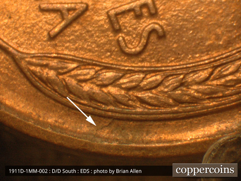 Die-stage A marker on 1911D•1MM•002 showing Die crack from rim to wheat on right side.