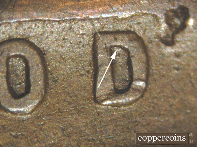 Die-stage C marker on 1911D•1MM•002 showing A thin die scratch shows at the top inside of the D of God.