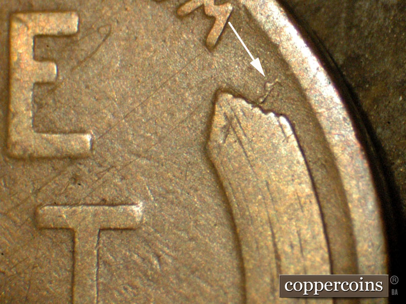 Die-stage C marker on 1911D•1MM•002 showing Die crack extends to the northeast from the right wheat tip.