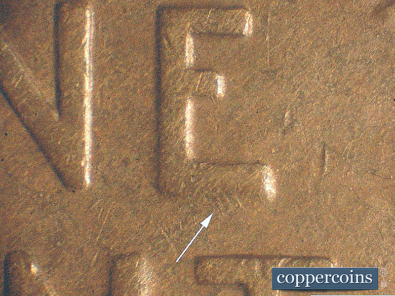 Die-stage A marker on 1911D•1MM•003 showing Die scratches at bottom of E in ONE.