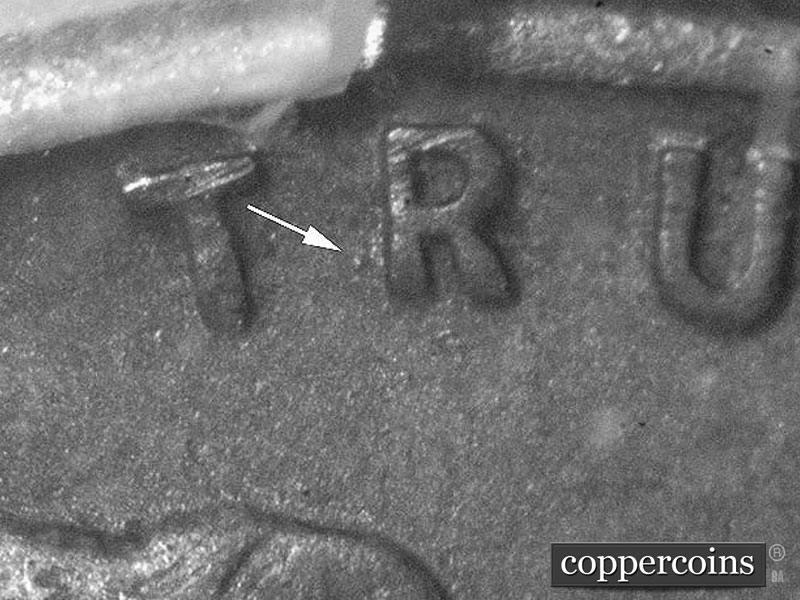 Die-stage B marker on 1911D•1MM•003 showing Die dot to lower left of R of TRUST.