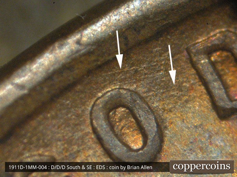 Die-stage A marker on 1911D•1MM•004 showing A few parallel die scratches show north and northeast of the O of GOD.