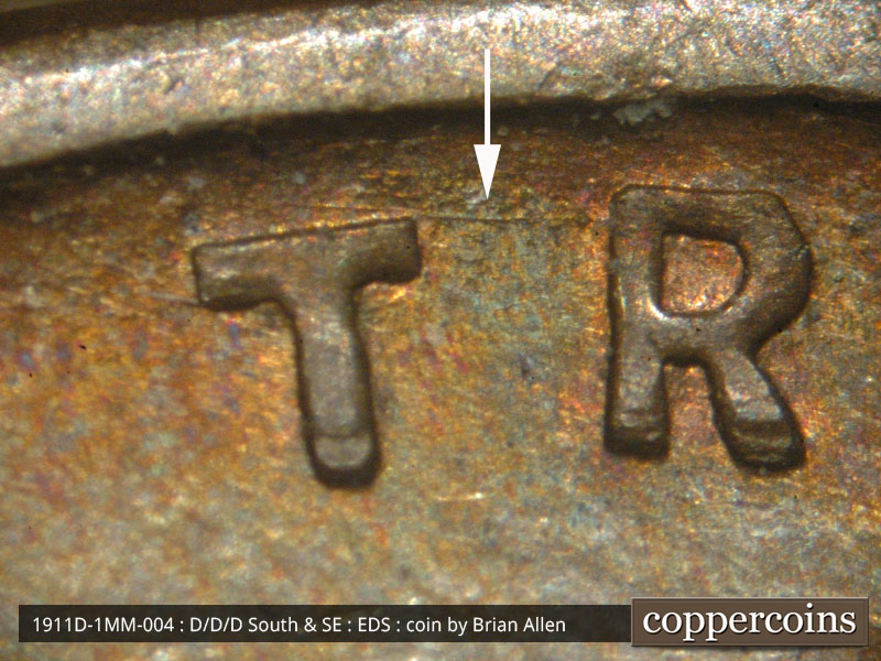 Die-stage A marker on 1911D•1MM•004 showing Light die scratches show above the TR of TRUST.