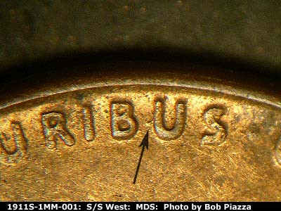 Die-stage B marker on 1911S•1MM•001 showing The die gouge on the left side of the second U of Pluribus.