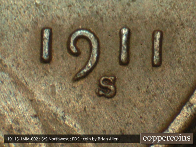 Die-stage A marker on 1911S•1MM•002 showing Wide shot of date and mint mark area.