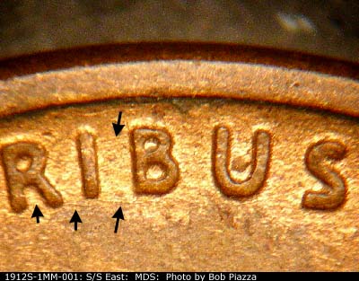 Die-stage B marker on 1912S•1MM•001 showing Die scratches between the top and bottom of the I and B of Pluribus.
