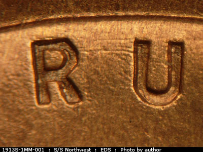 Die-stage A marker on 1913S•1MM•001 showing The die scratch shows running from the top of the R to the top of the U of trust.