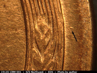 Die-stage A marker on 1913S•1MM•001 showing A didot shows to the east of the right wheat at the level of the top grain.