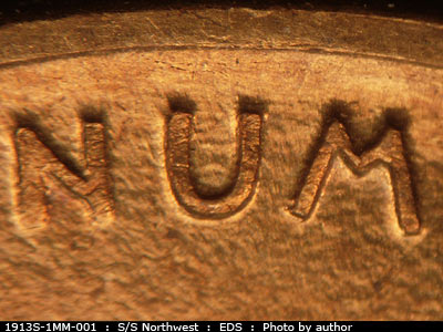 Die-stage A marker on 1913S•1MM•001 showing E and W dice scratches show In the middle of the U of Unum.