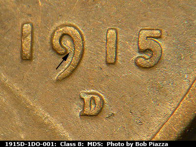Die-stage B marker on 1915D•1DO•001 showing Die scratches run NW-SE inside the curl of the 9 of the date.