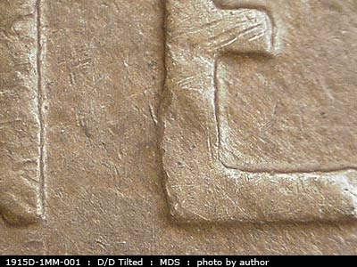 Die-stage B marker on 1915D•1MM•001 showing Die scratches show around the lower third of the E of ONE.