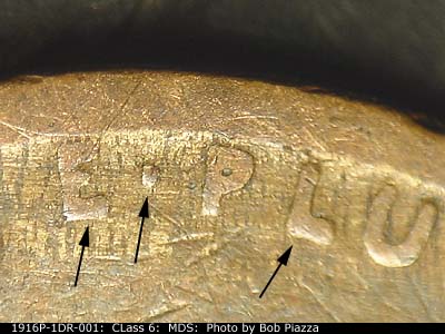 Die-stage B marker on 1916P•1DR•001 showing The left end of a Pluribus Unum showing the doubling.