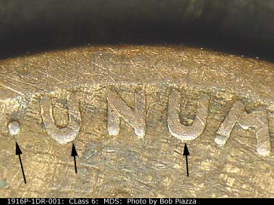 Die-stage B marker on 1916P•1DR•001 showing The right end of the Pluribus Unum showing the doubling.
