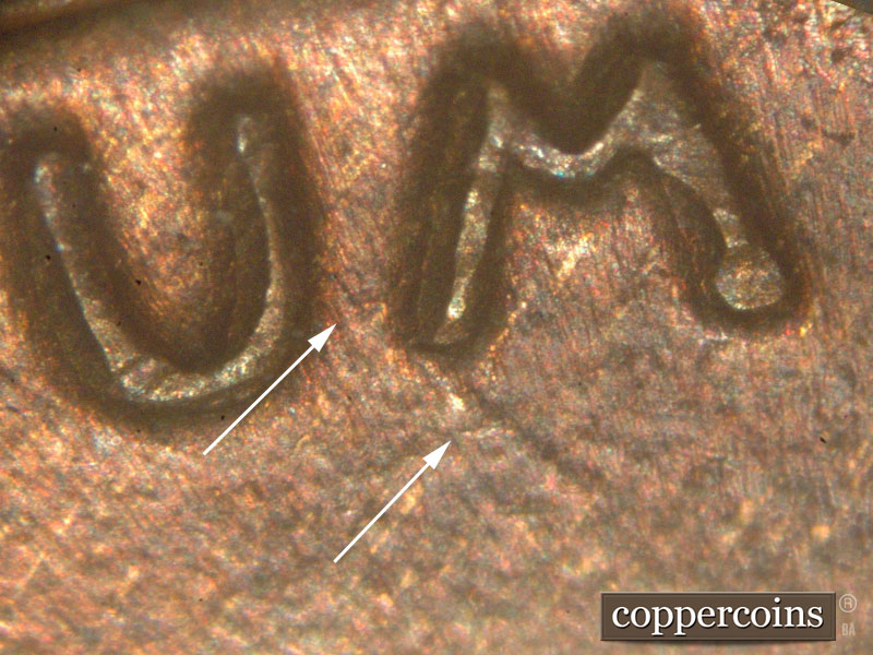 Die-stage C marker on 1917P•1DO•001 showing Die gouge near M in UNUM.