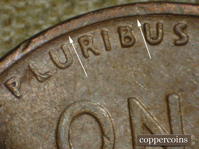 Die-stage A marker on 1917P•1DO•002 showing Concentric die scratch above PLURIBUS.