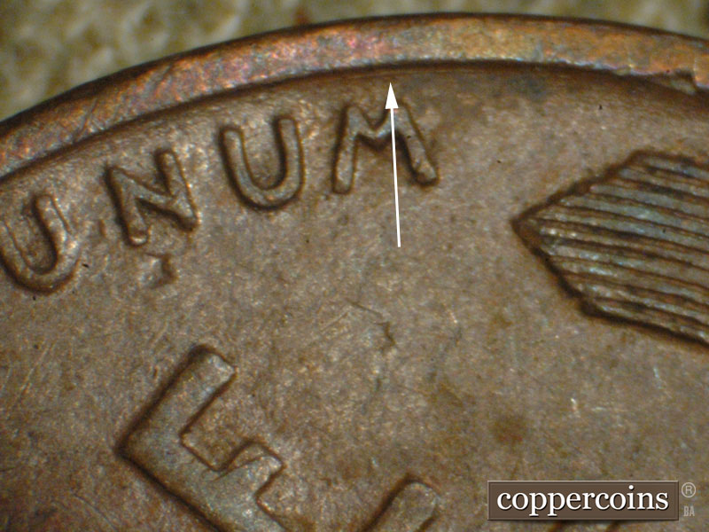 Die-stage A marker on 1917P•1DO•002 showing Concentric die scratch above UNUM.