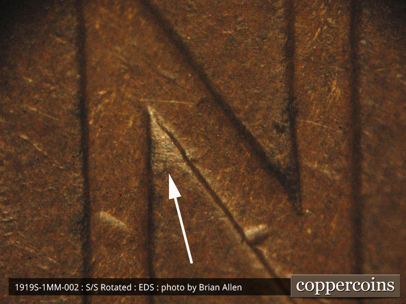 Die-stage A marker on 1919S•1MM•002 showing Closer image of the die gouge and scratches inside tj N of ONE.