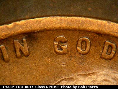 Die-stage B marker on 1923P•1DO•001 showing ESE die scratch in field between N of IN and G in GOD.