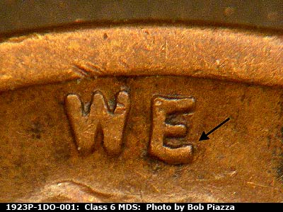 Die-stage B marker on 1923P•1DO•001 showing Extra thickness on E of WE.