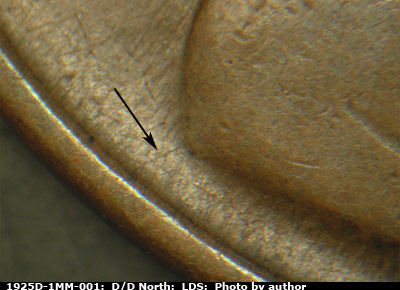 Die-stage C marker on 1925D•1MM•001 showing A die crack extends from the rim to the coat.