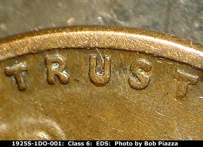 Die-stage A marker on 1925S•1DO•001 showing Extra thickness shows on the motto.