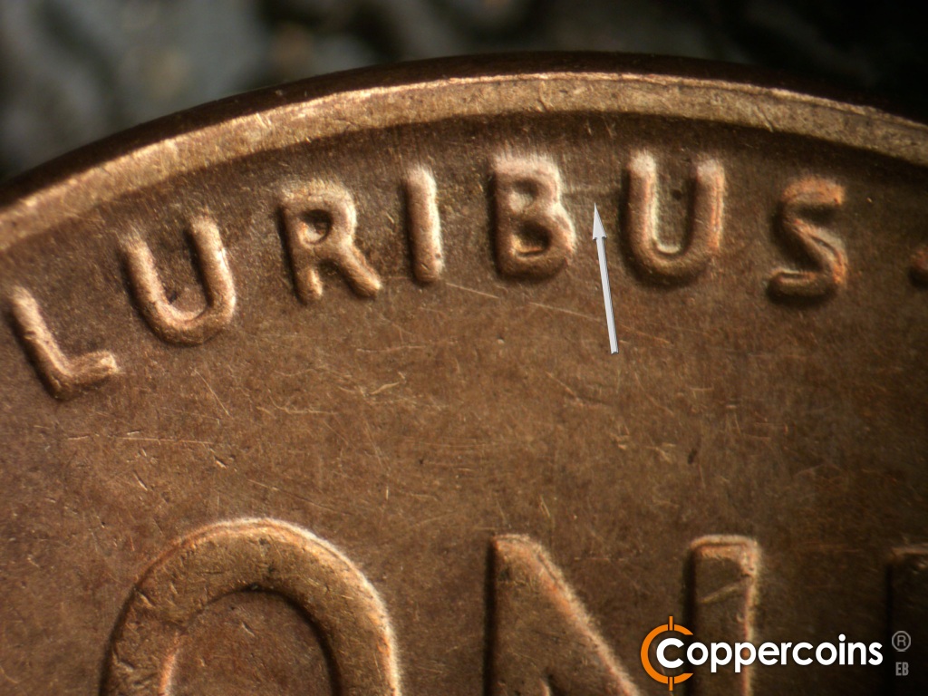 Die-stage B marker on 1929S•1MM•001 showing E/W die gouge connects BU in PLURIBUS.